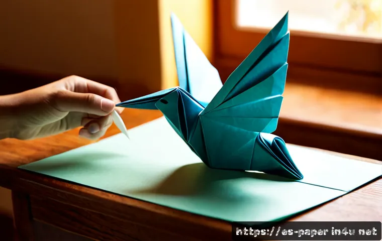 기타 종이 공예 기법 - Photorealistic close-up of skilled hands creating an intricate origami bird from richly colored pape...